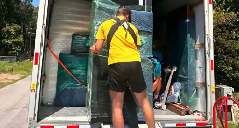 Office movers handling desks and equipment