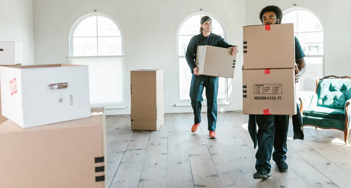 Movers carrying boxes into a Hood County home